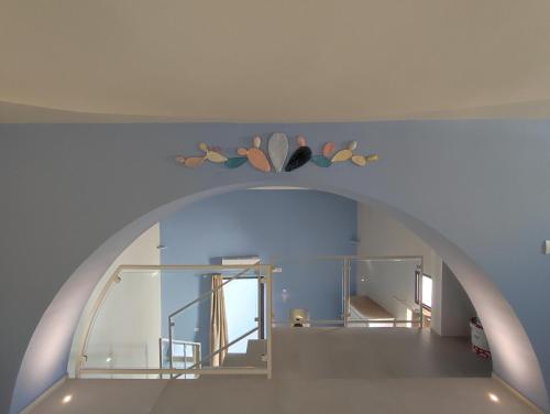 an archway in a room with a mirror and a staircase at Corte Piri in Tricase