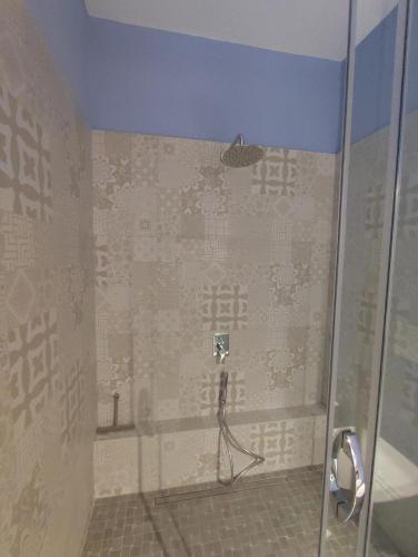 a shower in a bathroom with a tiled wall at Corte Piri in Tricase