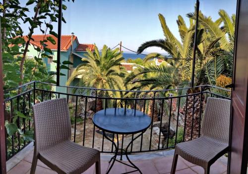 a patio with two chairs and a table on a balcony at Blue Star 2 in Pyrgi Thermis