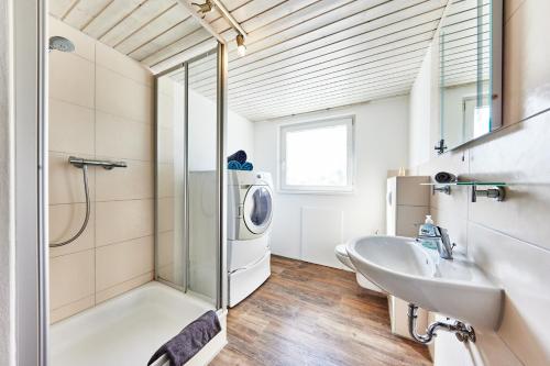 een badkamer met een wastafel en een wasmachine bij Charmant, zentral, nur 5 Gehminuten vom Europa-Park in Rust
