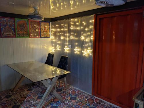 a table and chairs in a room with lights on the wall at HOTEL THE CUBE STAY in New Delhi