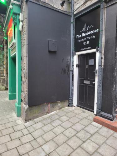 a black building with a sign on the side of it at The Residence - NO 8 in Edinburgh