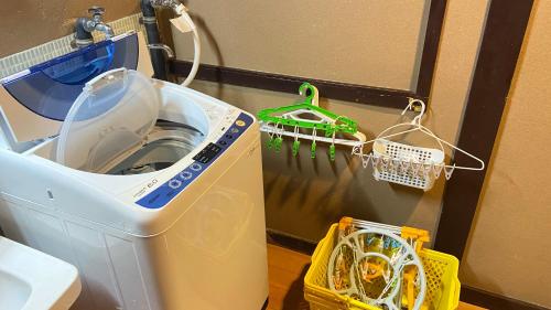 a washing machine sitting in a room with at ゲストハウス　華屋 (guest house HANAYA） in Sado