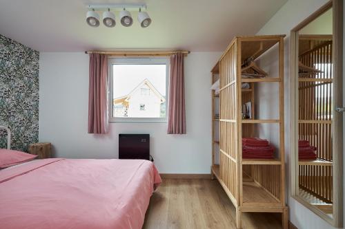 a bedroom with a bed and a book shelf at Sarnia Łąka Domek 2 z opcją prywatnego jacuzzi in Stronie Śląskie