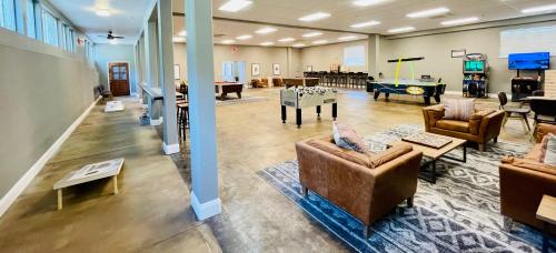 a living room with couches and a pool table at Yosemite View Lodge in El Portal