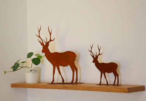 a wooden figurine of two deer on a shelf at Gasthof zur Traube in Bühl