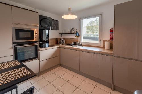 a kitchen with stainless steel appliances and a window at T3 Flat Moderne sur 2 étages Metro Parking Free Entrance autonome in Rouen
