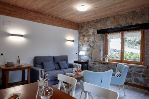 a living room with a couch and a table and chairs at Apartamentos Ea Astei in Ea
