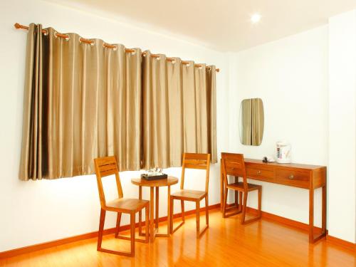 a room with a table and chairs and a desk at Double DD House at MRT Sutthisarn in Bangkok