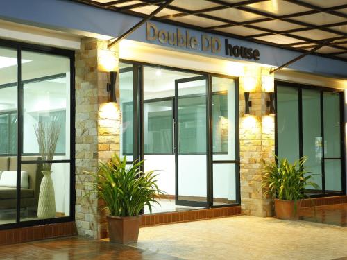 a building with a douglass ddb house sign on it at Double DD House at MRT Sutthisarn in Bangkok