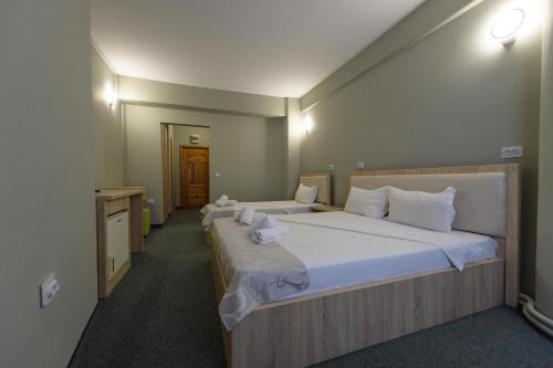 Postel nebo postele na pokoji v ubytování Hotel Cora