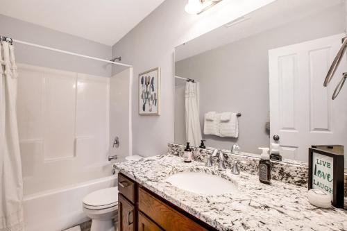 a bathroom with a sink and a toilet and a mirror at Hidden Valley Haven in Cle Elum