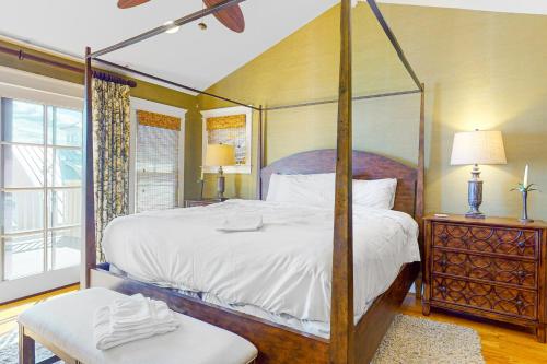 a bedroom with a four poster bed and a window at Sunset Island - Beachside Mews 1 & 2 in Ocean City