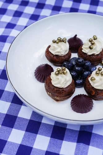 a plate of chocolate cupcakes on a table at Hostellerie De Levernois in Levernois