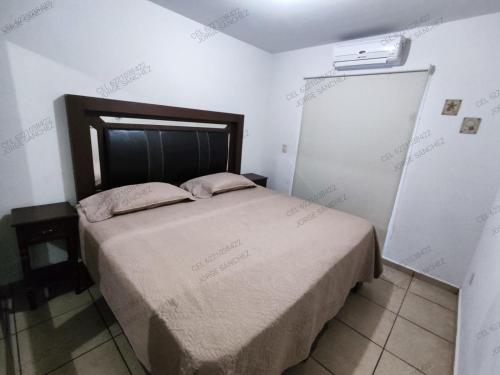 a small bedroom with a bed in a room at Casa Villa Serena 8 in San Carlos