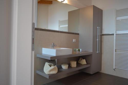 a bathroom with a sink and a mirror at Residence La Villa Tignale in Tignale