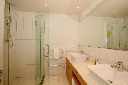 a bathroom with a shower and a sink at Lakeside Apartments in Wanaka