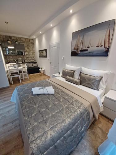 a bedroom with a large bed and a living room at Placeta Apartments in Dubrovnik