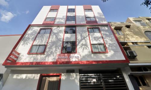 a tall building with red and white paint on it at Itsy By Treebo - Aflah in Hyderabad