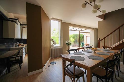 a kitchen and dining room with a table and chairs at Evasion in Albi