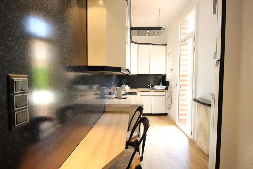 a kitchen with a table and chairs in a room at Evasion in Albi