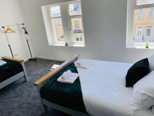 a room with two beds and two windows at Barry Townhouse in Barry