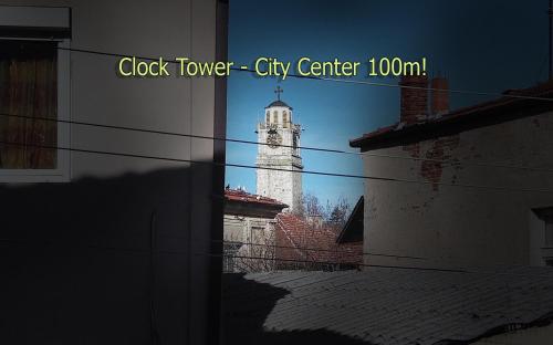 a building with a clock tower in a city center at Goldy Hostel in Bitola