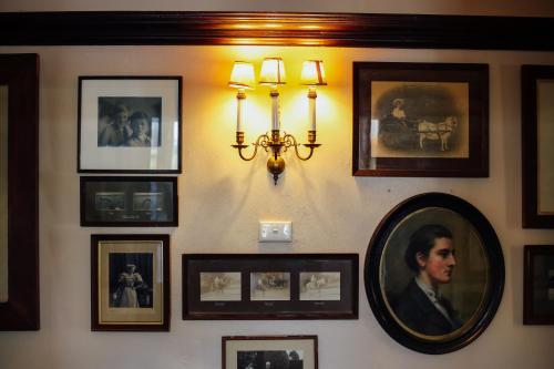 a wall with pictures and a mirror on it at Mount William Station in Willaura