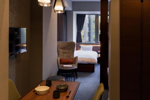 Postel nebo postele na pokoji v ubytování COCOSHUKU Shinjuku-Hanazono
