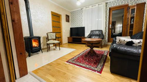 a living room with a couch and a wood stove at Gemütliches Apartment mit Kamin und Wohnküche in Herzberg am Harz