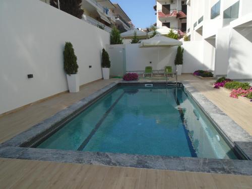 a swimming pool in the middle of a building at ASTERIAS Apartment in Kallithea Halkidikis