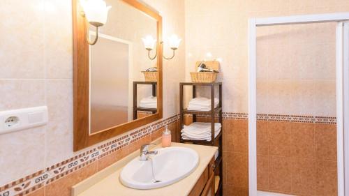 ein Bad mit einem Waschbecken und einem Spiegel in der Unterkunft Casa La Fajara 2 Canillas de Aceituno by Ruralidays in Canillas de Aceituno