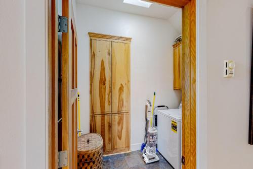 a kitchen with a wooden cabinet in a room at The Coquille River Retreat in Bandon