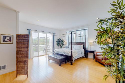 a bedroom with a canopy bed and a couch at The Coquille River Retreat in Bandon