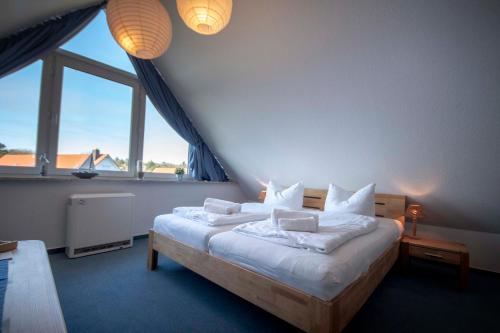 מיטה או מיטות בחדר ב-Ferienwohnung Hamburger Straße 7OG in Cuxhaven
