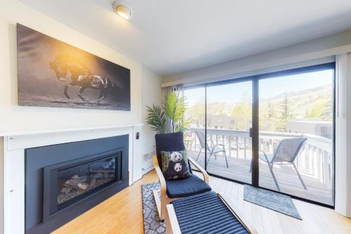a living room with a fireplace and a balcony at Vail View Dreams in Vail