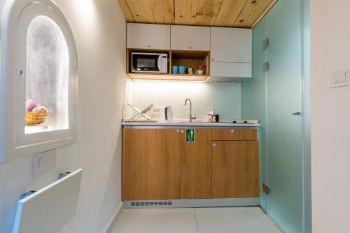 a small kitchen with a sink and a microwave at City Passage Apartments in Belgrade