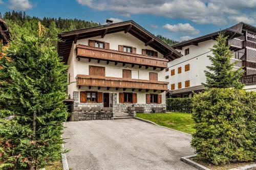 a large house with a driveway in front of it at Villetta Campiglio in Madonna di Campiglio