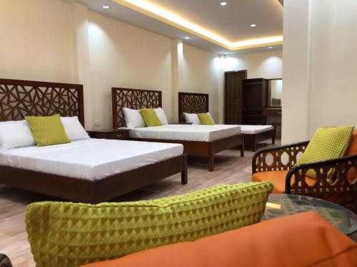 PMG Islandscape Resort في سيكويجور: غرفة بسريرين وطاولة وكراسي