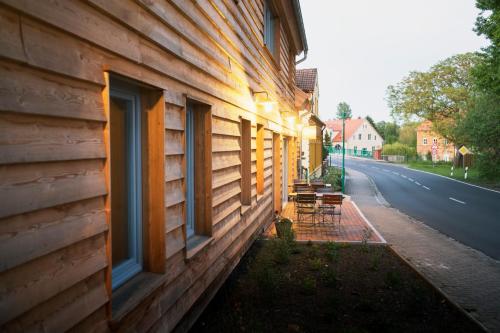 a building with windows on the side of a street at Gasthaus Canow in Wustrow