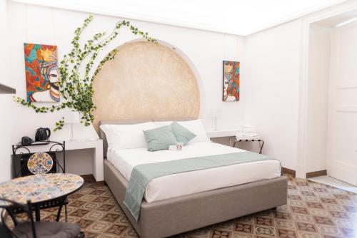 a bedroom with a bed with areath on the wall at B&B i MORI in Catania