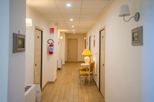 a hallway of a hospital with a table and chairs at Residence O'Sole Mio Pompei in Pompei