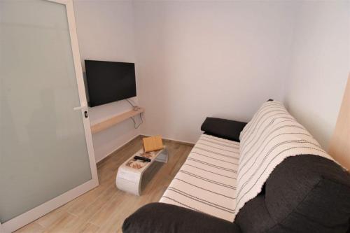 a living room with a couch and a flat screen tv at Ishel Trafalgar in Zahora