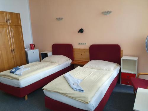 two beds in a small room at Pension zum Lichtenberger in Berlin