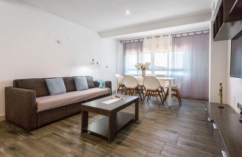 een woonkamer met een bank en een tafel bij Apartments Vistas Mar Bahia in Cádiz