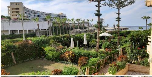 a garden with plants and trees and a building at 2bed rooms 95m, Garden&sea view, first floor, Family only دور اول بمدخل مستقل in Alexandria