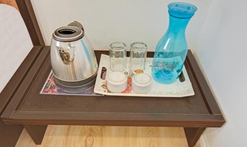 a table with a vase and other items on it at Treebo Villa Inn Aurangabad in Aurangabad