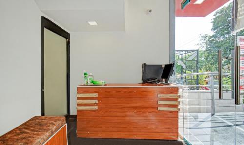a room with a wooden dresser with a laptop on it at Treebo Villa Inn Aurangabad in Aurangabad