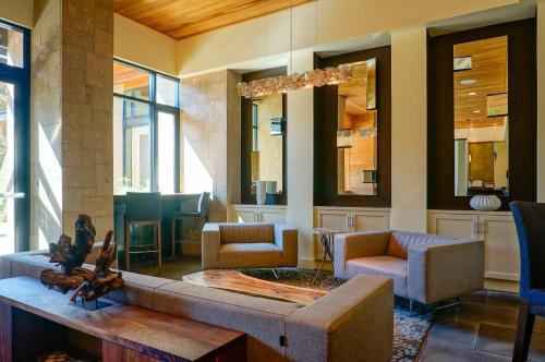 a living room with a couch and a fireplace at Bardessono Hotel and Spa in Yountville