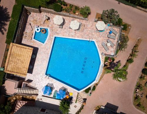 an overhead view of a swimming pool with umbrellas and chairs at Marni Village in Hersonissos